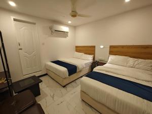 Postel nebo postele na pokoji v ubytování Hotel Graceland Skardu
