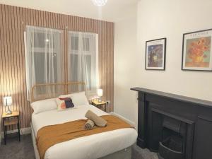 a bedroom with a bed and a fireplace at 3 BD Luxury Stay For Contractors & Families in Newcastle upon Tyne