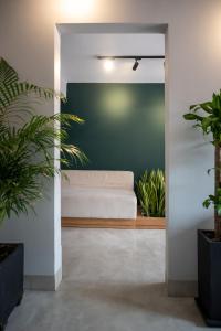 a living room with a couch and potted plants at Hotel Santa Ana Medellin in Medellín