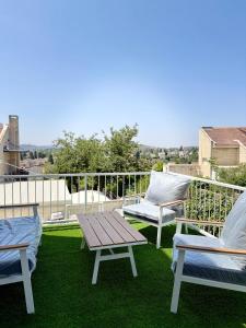 a patio with two chairs and a table on a balcony at Sara exclusive in Mevasseret Zion