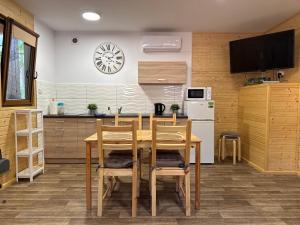 a kitchen with a table and chairs in a room at Świerkowy domek in Boszkowo +10 photos