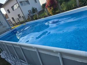 a large blue swimming pool in a yard at Vila Mirsada in Sarajevo