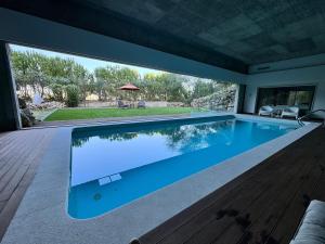 a large swimming pool in a house at The Bungalow - Quinta da BellaVista in Almoster