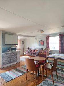 a living room with a table and chairs and a couch at Lomakylä Lapponia in Inari