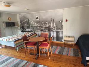 a bedroom with a bed and a table and chairs at Lomakylä Lapponia in Inari