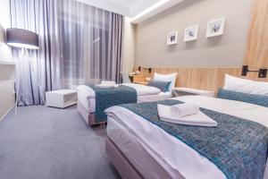 Posteľ alebo postele v izbe v ubytovaní Hotel Falcon