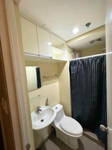 a small bathroom with a toilet and a sink at Avida Towers IT PARK in Cebu City