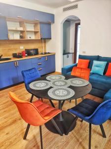 a living room with a table and chairs and a couch at Alpin Confort Predeal in Predeal