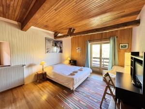 a bedroom with a bed in a room with wooden ceilings at Chalet La Mouree 1790 - CHALET LA MOUREE 1790-Tout inclus-Classé 4 MAE-2101 in Vars
