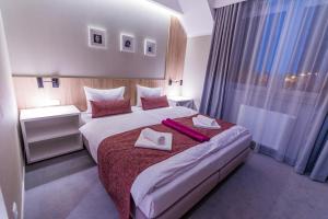 Posteľ alebo postele v izbe v ubytovaní Hotel Falcon