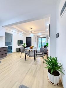 a dining room and living room with a table and chairs at M&D Zenith Place in Nairobi