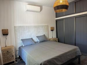 a bedroom with a large bed with blue pillows at Balsamaris in Manta Rota