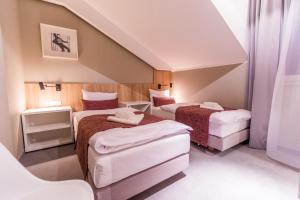 Posteľ alebo postele v izbe v ubytovaní Hotel Falcon