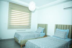a bedroom with two beds and a window at Beautiful sea view El Fatha Kelibia in Kelibia +13 photos