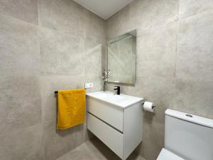 a bathroom with a white sink and a mirror at Ático con terraza, garaje y muy céntrico in O Grove +72 photos