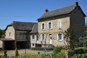 an old stone house with a black roof at Lou Caussinhol 3 épis in Montbazens