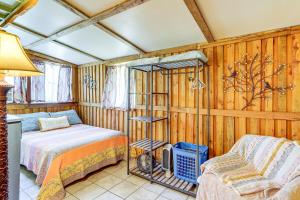 a bedroom with a bed and a chair in a room at Near Tampa Attractions Boho Bungalow on 20 Acres! in Lutz