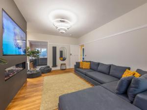 a living room with a couch and a flat screen tv at Bryndedwydd in Borth
