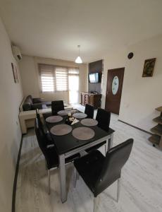 a living room with a dining room table and chairs at Зара Апартамент in Stara Zagora