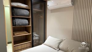 a bedroom with a bed and a closet with ahaarhaarhaarhaarhaarhaar at Modern apt next to Criamigos Park + coffee Day 1 in Gramado