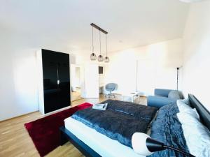 a living room with a bed and a couch at Living Graz Eggenberg Top 17 in Graz