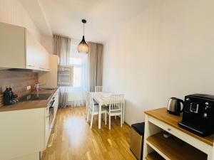 a kitchen with a table and a dining room at Living Graz Eggenberg Top 17 in Graz