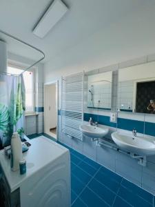 a bathroom with two sinks and two mirrors at Villa Rebuli - room One - zentral in Top 3 in Leitendorf
