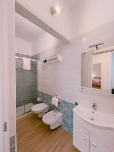 a bathroom with two toilets and a sink and a mirror at " la TONNARA CASA VACANZE " in Porto Cesareo +58 photos