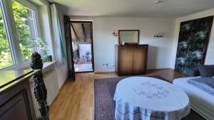 a living room with a white table and a couch at Abendsonne in Saulgrub