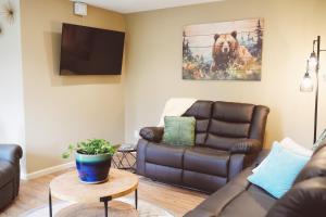 a living room with a couch and a dog painting at Lakeshore Lodging Apartment F in Homer