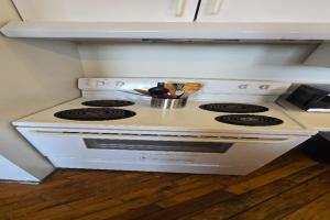 a white stove top oven in a kitchen at Detroit MotorCity Riverfront Loft in Detroit +11 photos