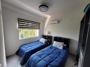 a bedroom with two beds and a window at Paktinemi Diamante Fantastic View Beach Club in Acapulco +53 photos