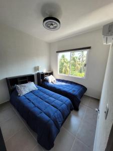 a bedroom with two beds and a window at Paktinemi Diamante Fantastic View Beach Club in Acapulco