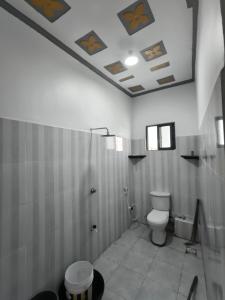 a bathroom with a toilet and a shower at Mama Abayi Fakhi in Mombasa +16 photos