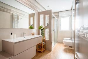 a bathroom with a white sink and a mirror at DaDa Luxury Home in Bari +33 photos