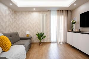 a living room with a couch and a tv at DaDa Luxury Home in Bari