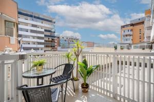 a balcony with a table and chairs and a view of the beach at DaDa Luxury Home in Bari