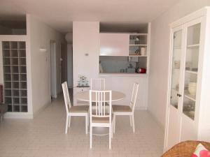 a kitchen and dining room with a table and chairs at Le serpent de mer in Le Grau-du-Roi