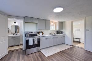 a kitchen with white cabinets and a stove top oven at Homestead Haven in Gettysburg