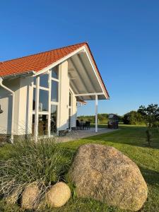 a house with a large rock in front of it at Villa Ostseebrise in Trent