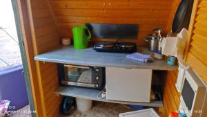 a table in a tiny kitchen with a microwave at "Saunahotel" mit separatem Badezimmer in Meinerzhagen