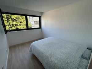 a bedroom with a bed and a large window at Apartment 8 min Orly, 2 min RER, bus direct Orly in Ablon-sur-Seine