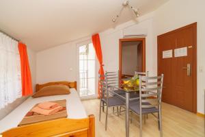 a bedroom with a bed and a table and chairs at Kuca Orhidea in Crikvenica +78 photos