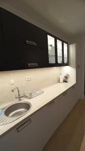 a bathroom counter with a sink and two windows at Premium Oasis Beach Club Apartment in Lozenets +23 photos