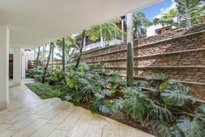 a courtyard with plants and a brick wall at Casa del Sol in La Romana