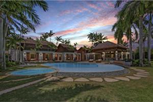 a house with a swimming pool in a yard at Casa del Sol in La Romana