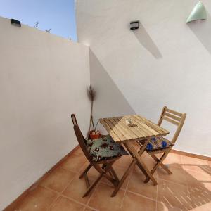 a wooden table and two chairs in a room at Casa Papaya19 in Sal Rei +33 photos