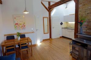 a kitchen and dining room with a table and chairs at Sonnenlandhof in Neuruppin