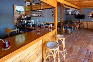 a bar with wooden floors and wooden tables and chairs at Mistral Alaçatı Hotel in Çeşme