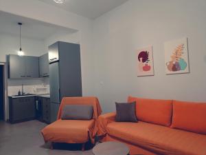 a living room with a couch and a chair at Mira apartment in Skiros